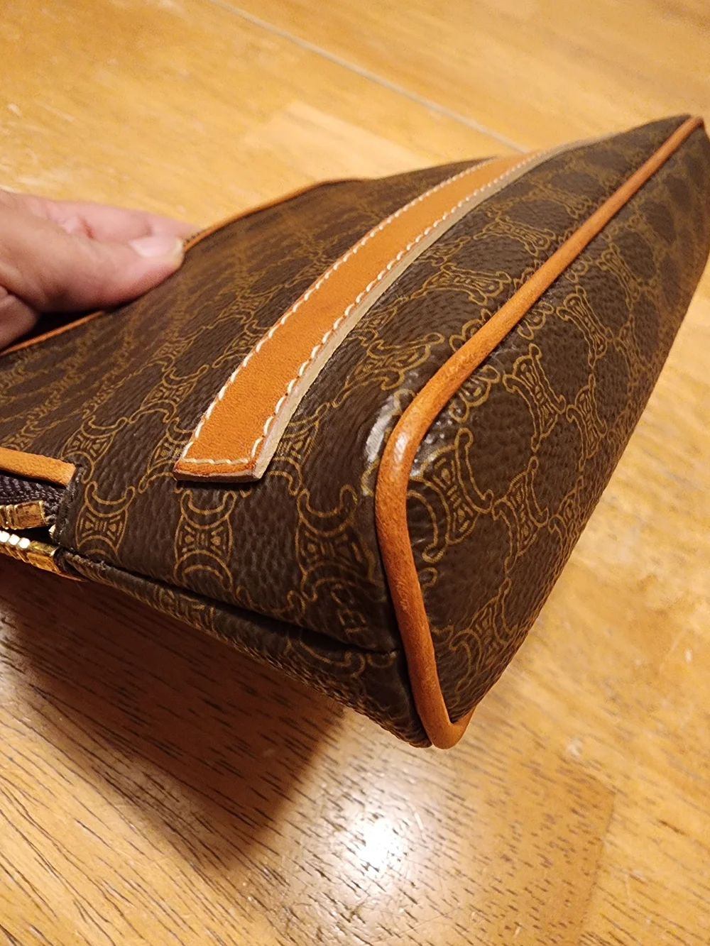 CELINE pouch is crafted from brown Triomphe canvas and features tan leather trim